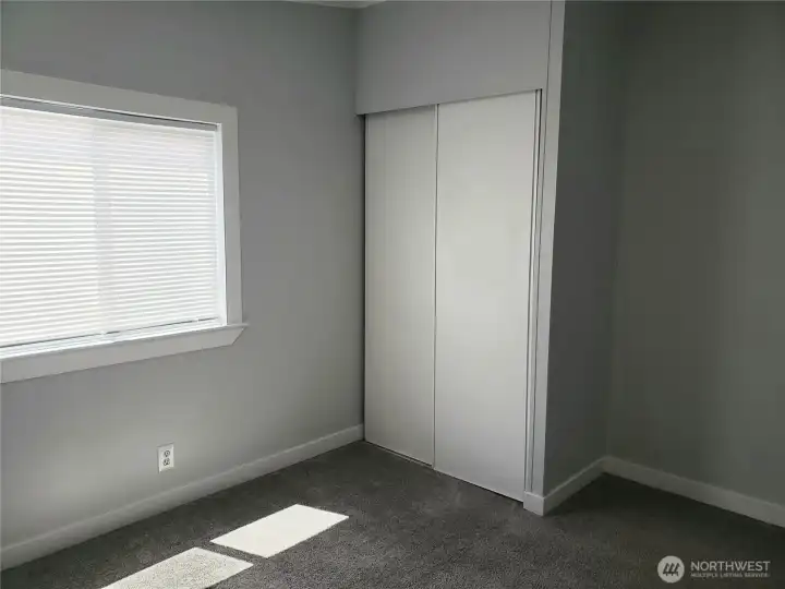 Nice Size Second Bedroom with New White Window/Floor Trim, Closet, and New Carpeting.
