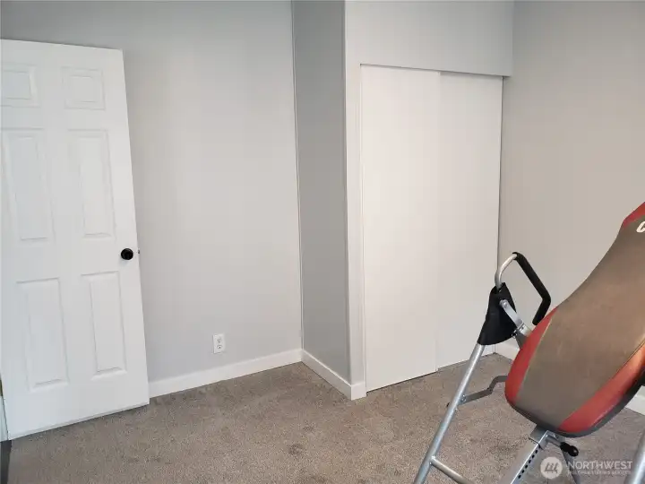 A Picture of the Nice Size Third Bedroom with New White Window/Floor Trim, Closet, and New Carpeting.