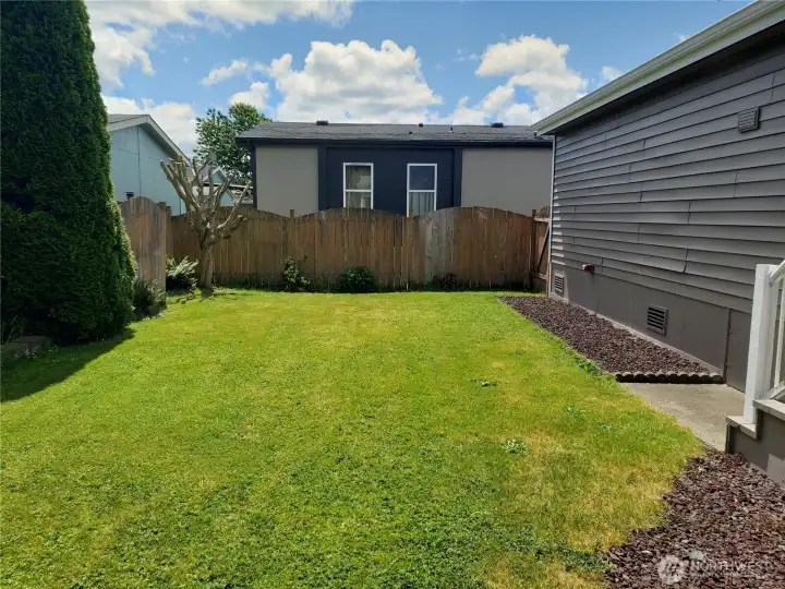 A Picture of the Large Pet Friendly Fenced Backyard with Easy Care Landscaping.