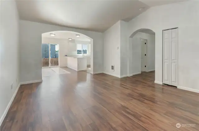 Artistic archways leading to kitchen and hallway.