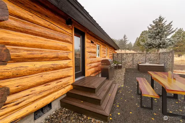 Beautiful gabion wind wall offers shelter while soaking in the hot tub.  BBQ is pre-plumbed for propane.