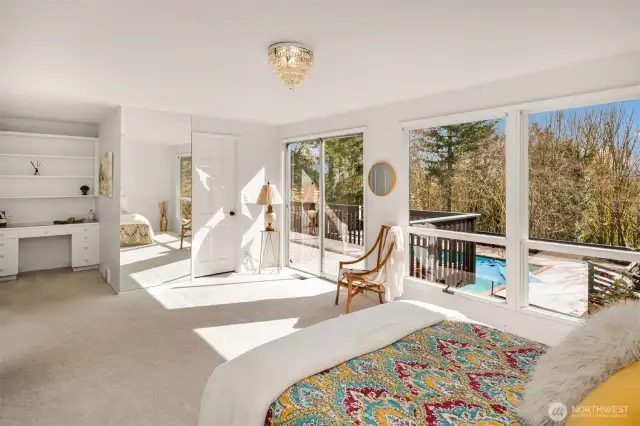 The primary suite opens directly to the expansive deck, offering serene views and the ultimate in privacy, creating a peaceful retreat.