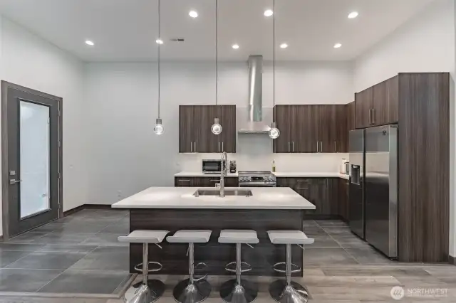 sleek cabinets, quartz counters, and stainless-steel appliances.