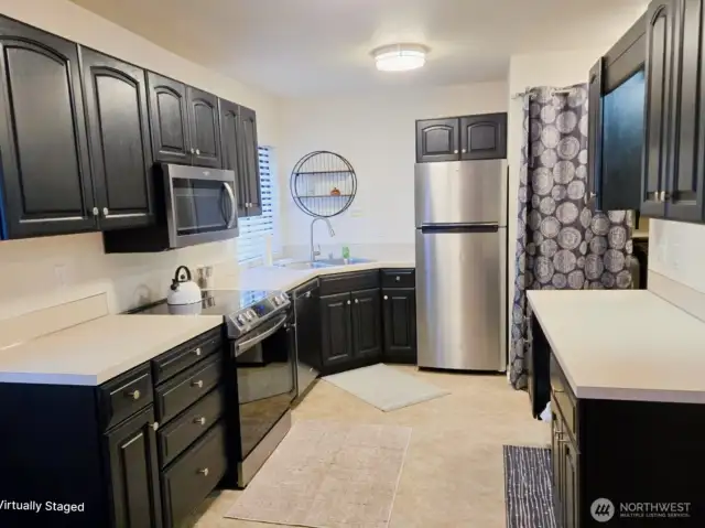 Kitchen of 6601, stainless steel appliances with top of the line glass stop Samsung stove, microwave and dishwasher.