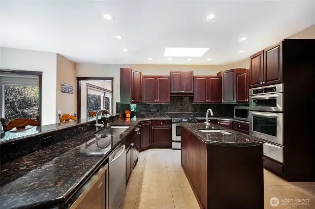 There is plenty of cabinetry space, ample countertops, 3 ovens + a warming oven, and a secondary prep sink.