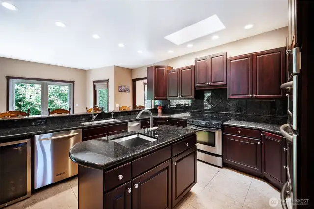The large commercial grade refrigerator is behind this photo, with a walk in pantry beside it and even an attached TV above.