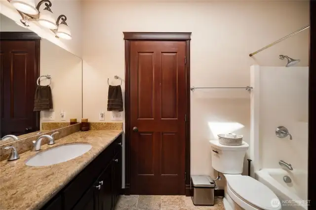 Full bathroom between the jack and jill bedrooms. The elegant style of the home consistently extends through the main level.