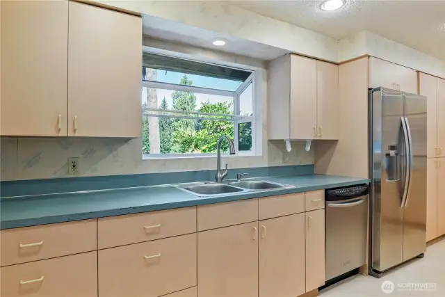 mauve laminate cabinets, beautiful territorial views out kitchen window.