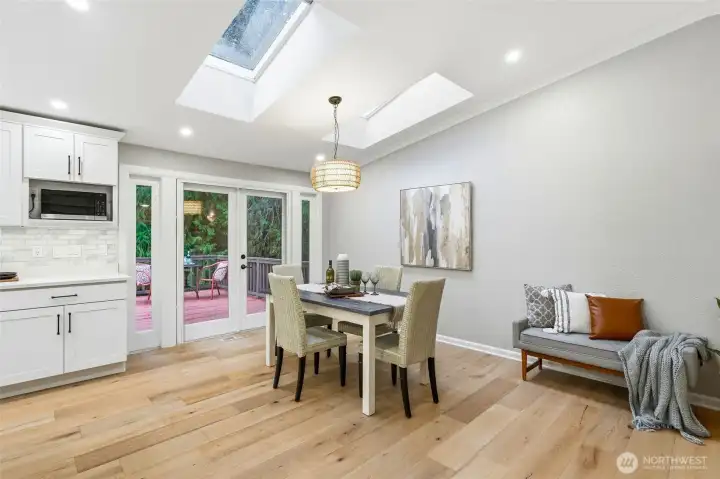 French doors open up to a large deck overlooking the sport court.