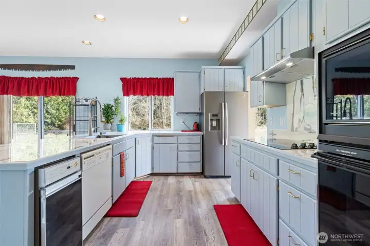 Light and bright updated kitchen makes cooking fun! The kitchen overlooks the expansive back yard and pasture~come see!