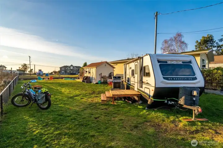 This fenced lot has power, water, sewer and internet - ready for you to make it yours.
