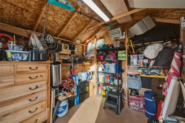 Storage shed for kayaks, paddleboards, bikes, and gear.