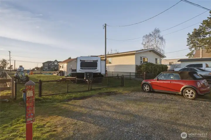 Ample gravel parking outside the fence.