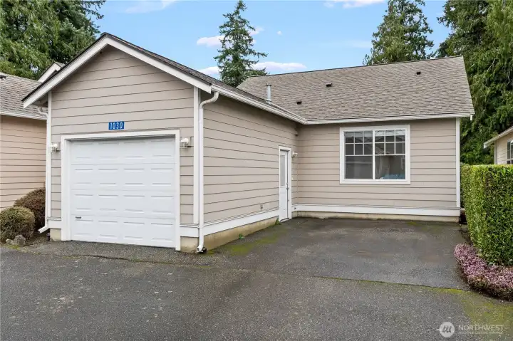Attached one car garage with additional parking space.