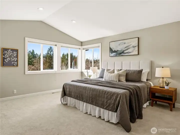 Upstairs, and through the French doors, you'll find that natural light and calm flood the primary bedroom