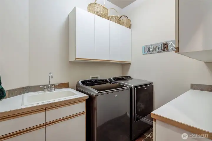 Convenient laundry room located just off the garage with additional storage space.