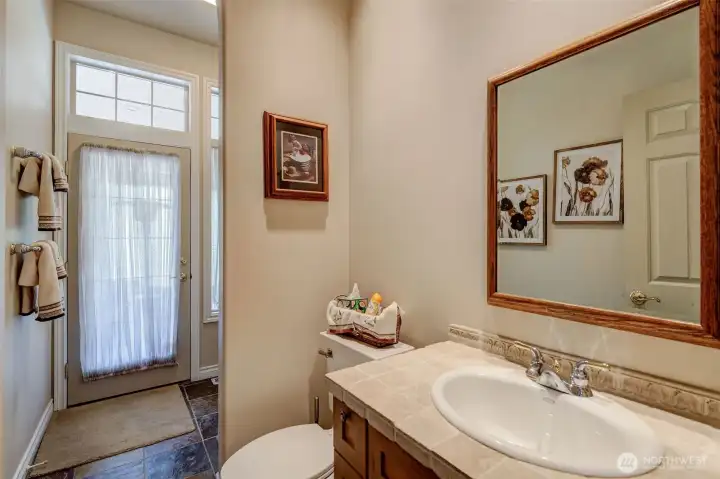 Dual-access main bathroom with direct entry from patio/hot tub and interior hallway, featuring double sinks and private water closet.