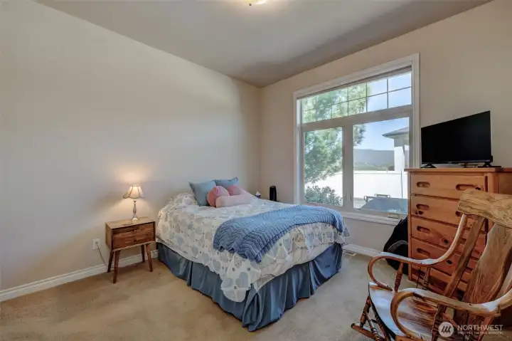 Secondary bedroom with large closet and natural light.