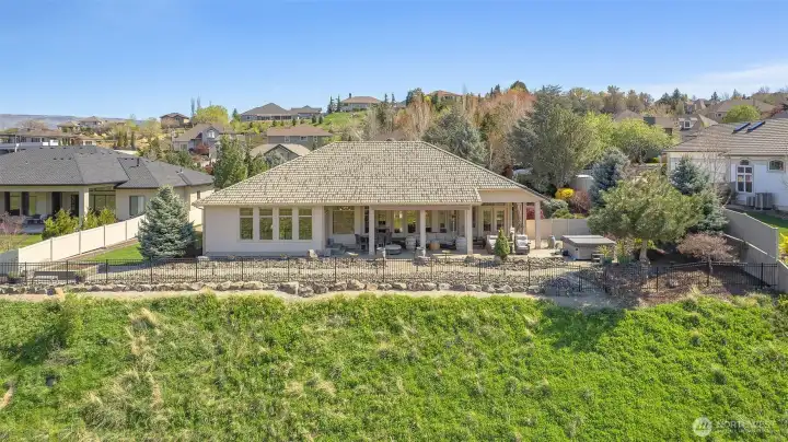 Peaceful outdoor setting with privacy, mature landscaping, and open sky views.