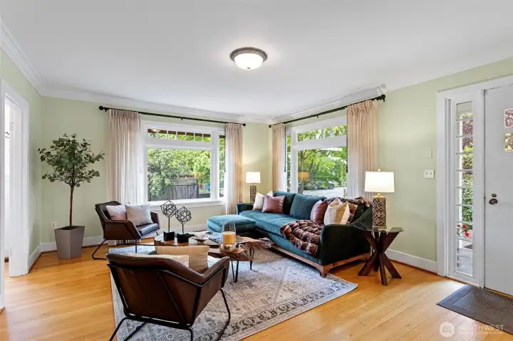 Large windows frame the greenery outside, blurring the line between the refined interior and the tended gardens.