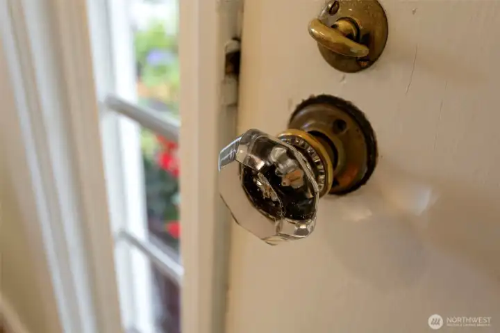 Original glass knobs, brass hardware, faceted octagonal glass. Still here, still working.