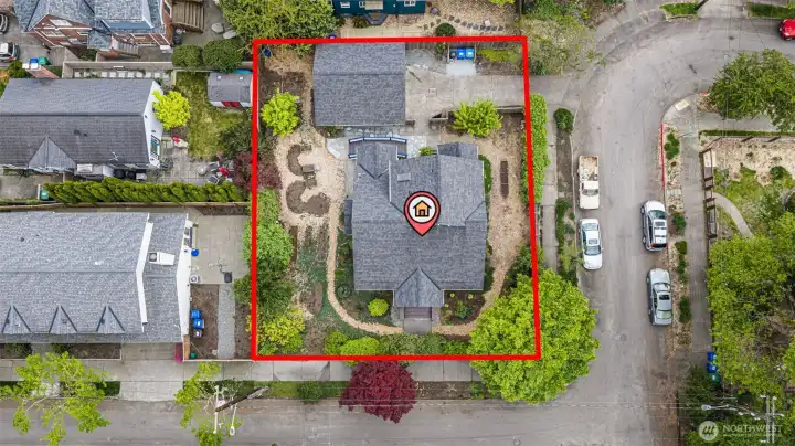 Flat corner lot at the top of the hill. 6,840 square feet. Detached garage, professional landscape, light from every side. A hundred years in — and the grounds are just hitting their stride.