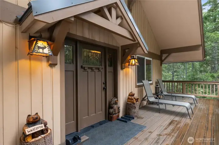 Beautiful front entry on this home. Large front deck with plenty of room to enjoy with friends. See the stunning timber framed front entry and oversized door with transoms on each side.