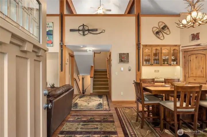 One you enter the front door you can see how cozy this stunning home/cabin is. Soaring ceilings and beautiful knotty alder trim, You can see the loft above in this photo.