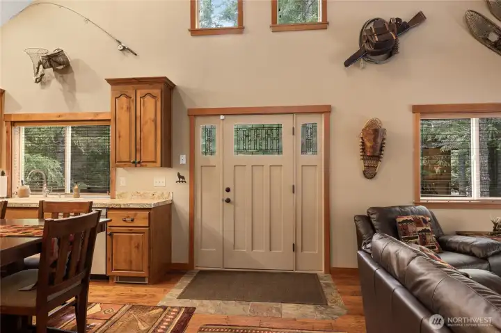 This cabin is decorated so well, lots of wall space to add your own decorations. Here you seen the front door entry that splits the kitchen area from the living room area.