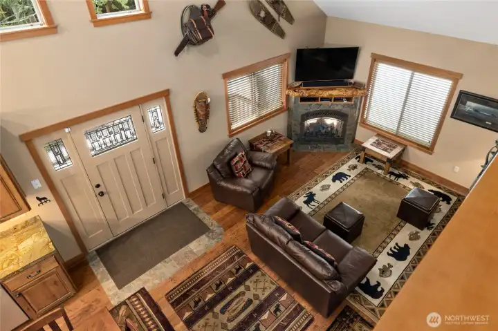 Peering over the railing from upstairs loft you have a great view of the lower level.