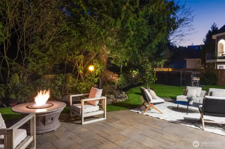 The backyard sanctuary includes elegant landscape lighting, a soothing fire table, and a saltwater swim spa for fitness and rejuvenation. The backyard sanctuary includes elegant landscape lighting, a soothing fire table, and a saltwater swim spa for fitness and rejuvenation.