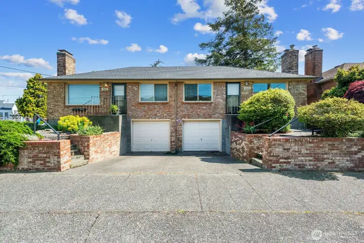 Well maintained triplex with two units with garages plus off street parking.