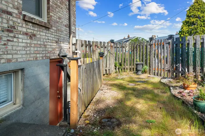 This red door is the access to the studio unit. The garden space is for this unit.