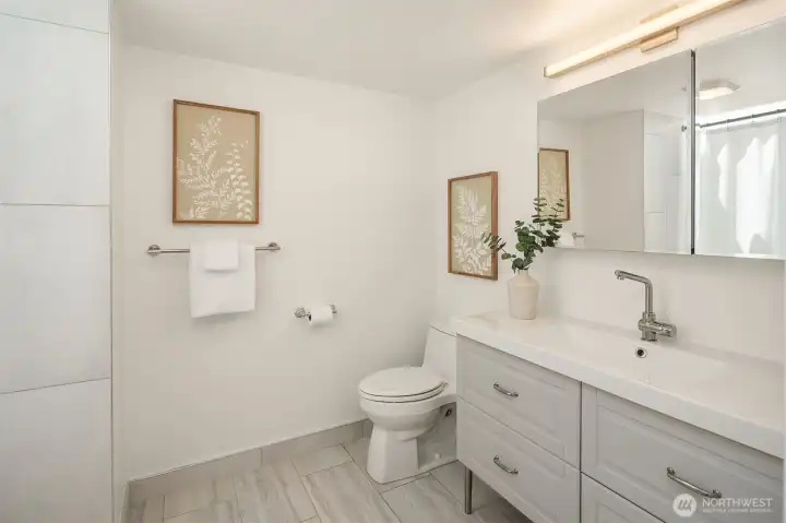 Full bath off the upper hallway with bright skylight.