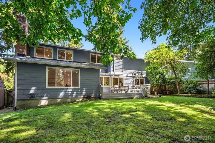 The deck leads down to a level play lawn.