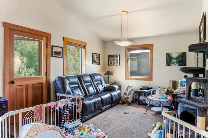 Vaulted ceilings and wood-framed windows in this living room overlooking the back yard. Vaulted ceilings and wood-framed windows in this living room overlooking the back yard.
