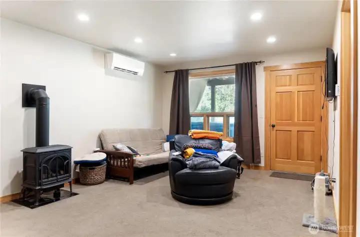 Downstairs bonus room with another propane stove and exit onto the back patio with hot tub. Downstairs bonus room with another propane stove and exit onto the back patio with hot tub.