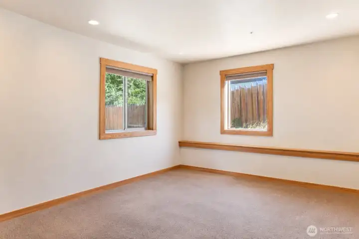 Larger of the two downstairs bedrooms. Photo cleared of all furniture and belongings using Chat GPT Larger of the two downstairs bedrooms. Photo cleared of all furniture and belongings using Chat GPT