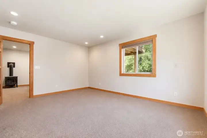 Larger of the two downstairs bedrooms. Photo cleared of all furniture and belongings using Chat GPT Larger of the two downstairs bedrooms. Photo cleared of all furniture and belongings using Chat GPT