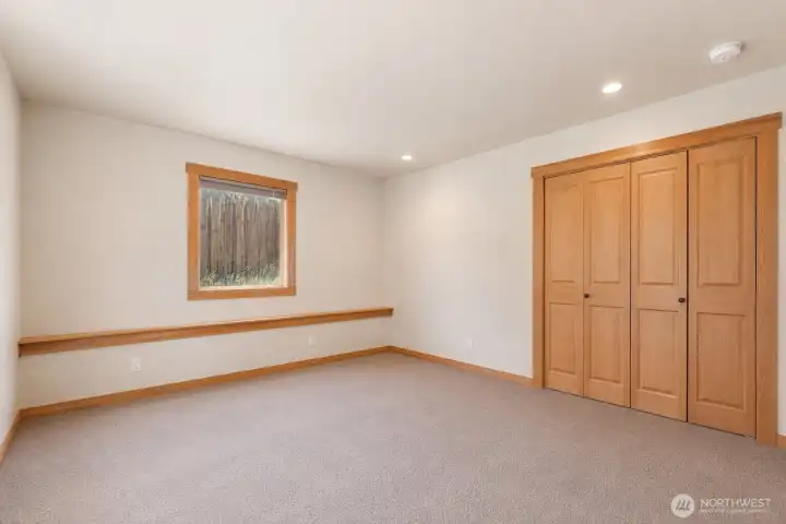 Larger of the two downstairs bedrooms. Photo cleared of all furniture and belongings using Chat GPT Larger of the two downstairs bedrooms. Photo cleared of all furniture and belongings using Chat GPT