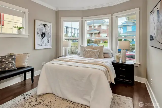 Bright & cheery primary BR lined with oversized bay windows