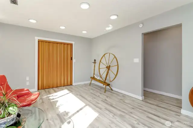 Extra finished room with accordion door to laundry.