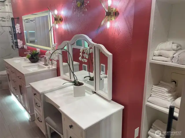 Primary bath with make-up station, small safe, and toe-kick lighting