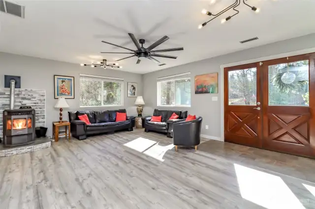 Living room and entry.  Pellet stove with whole house circulation keeping back bedrooms warm for winter comfort.