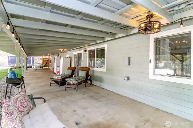 Full-length covered patio with lighting, great for year-round enjoyment and entertaining.  Wired for hot tub, 240V