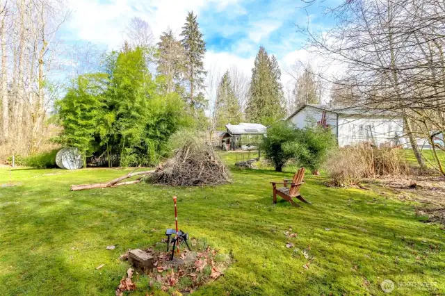 Back area with firepit and space for cornhole, badminton and other activities.