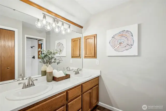Primary bath features dual vanities with great storage.