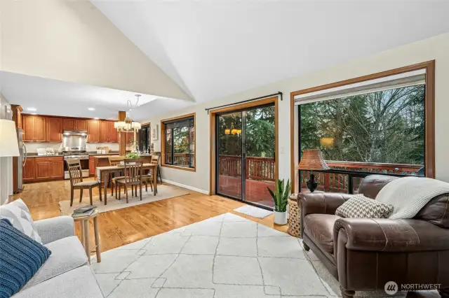 The kitchen features stainless steel appliances, granite counters, and hardwood floors flowing into a great room.