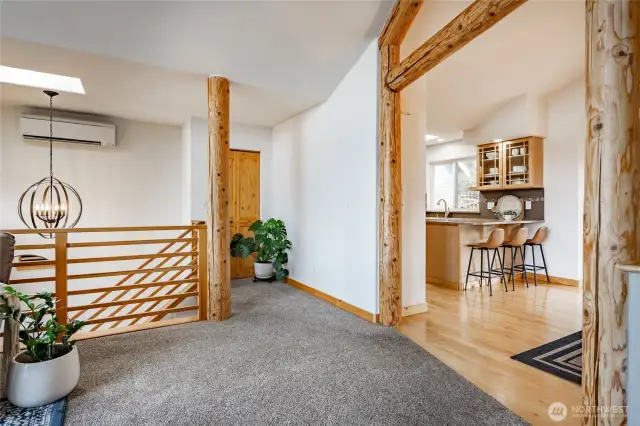 A view looking back into kitchen & dining room from the living area. New plush carpet and gleaming maple floors !