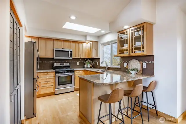 Efficient kitchen with new appliances, gorgeous granite countertops, classic glass cabinets and plenty of room for the Chef !
